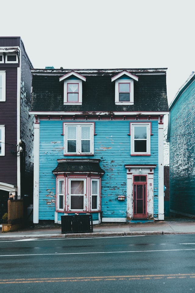 Blue house that needs new paint on the exterior