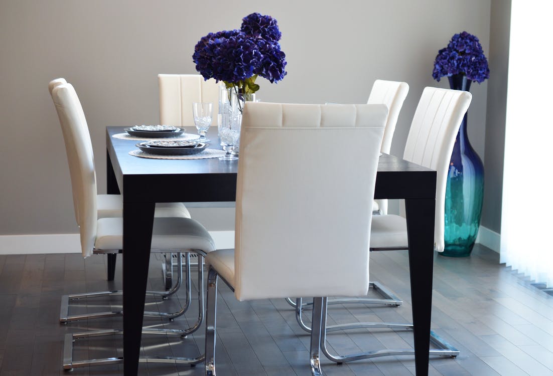 Diningroom table, five chairs, flowers