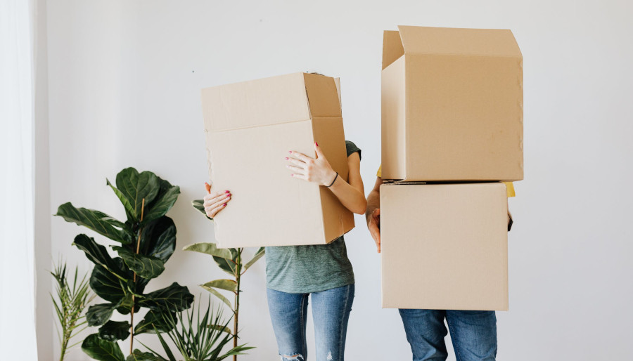 2 people standing with boxes