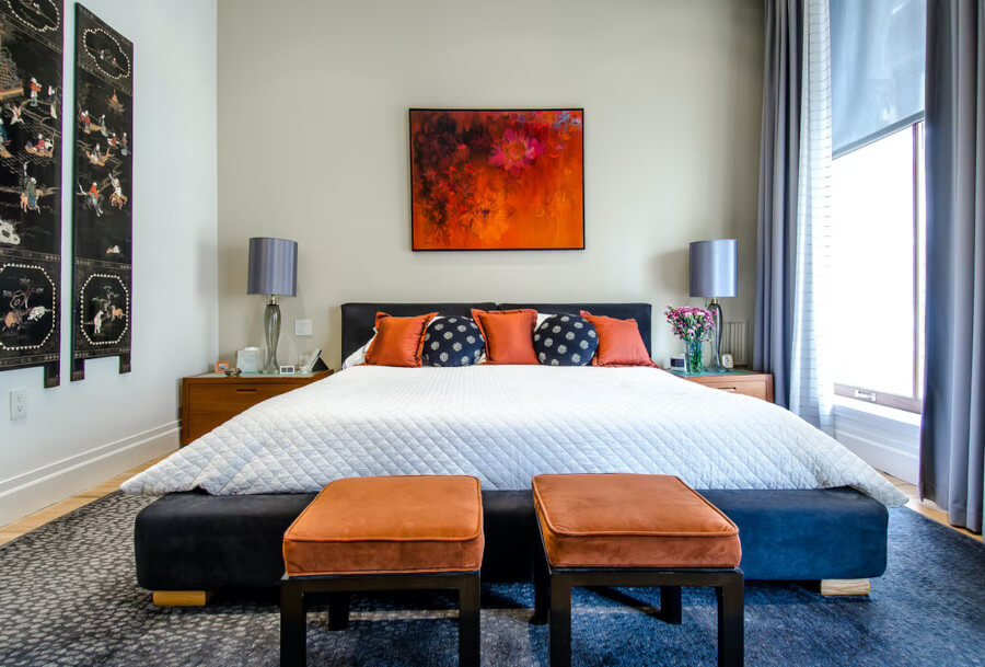 Bedroom with neutral colors on the bed and sofa and wall