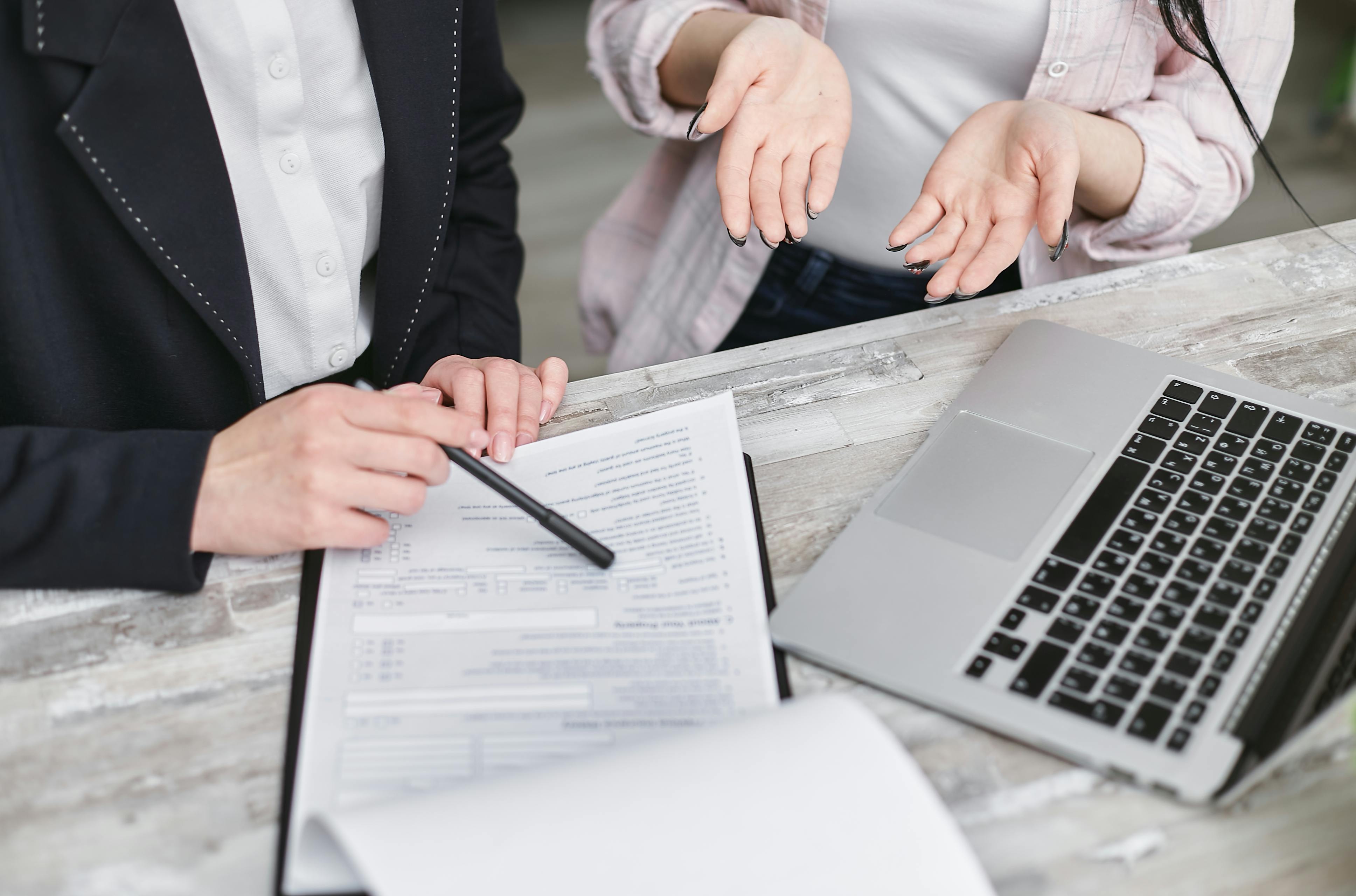 People going over paperwork. Image by Pexels