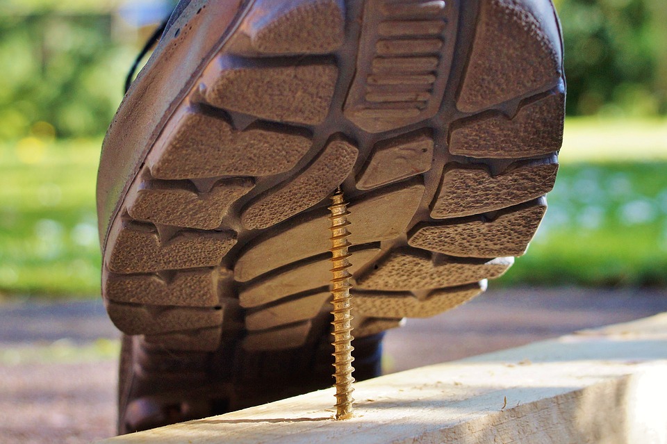 Shoe stepping on a nail