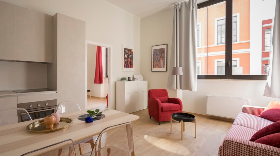 Kitchen, livingroom combo. Red and white furniture.