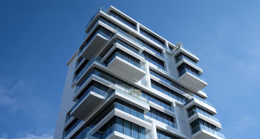 white apartment building, blue sky