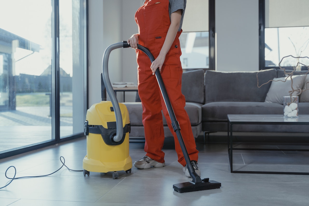 person using a yellow vaccum